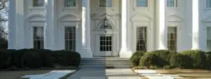 a gleaming white house exterior being power washed, revealing a sparkling clean surface underneath.